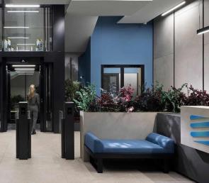 Green compositions of natural  preserved plants in planters at Smart Power Grid